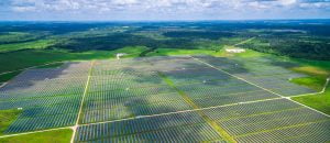 Solar Energy Farm Aerial over thousands of Solar Collectors